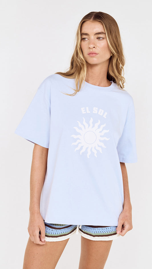 Relaxed Fit El Sol Print Tee in Pastel Blue worn by a model featuring sun graphic and relaxed fit.
