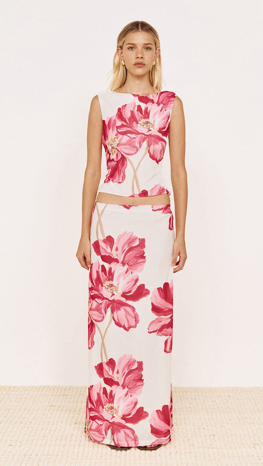 Pink Floral Mesh Top with Low Back worn with coordinating skirt, showcasing bold pink floral print design.