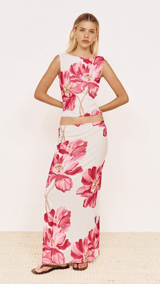 Model wearing a Pink Floral Mesh Top with Low Back paired with a matching skirt, showcasing a vibrant floral design.