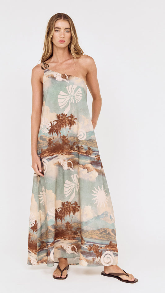 Model wearing the Island Print One Shoulder Maxi Dress featuring scenic island print and floor-grazing hem.