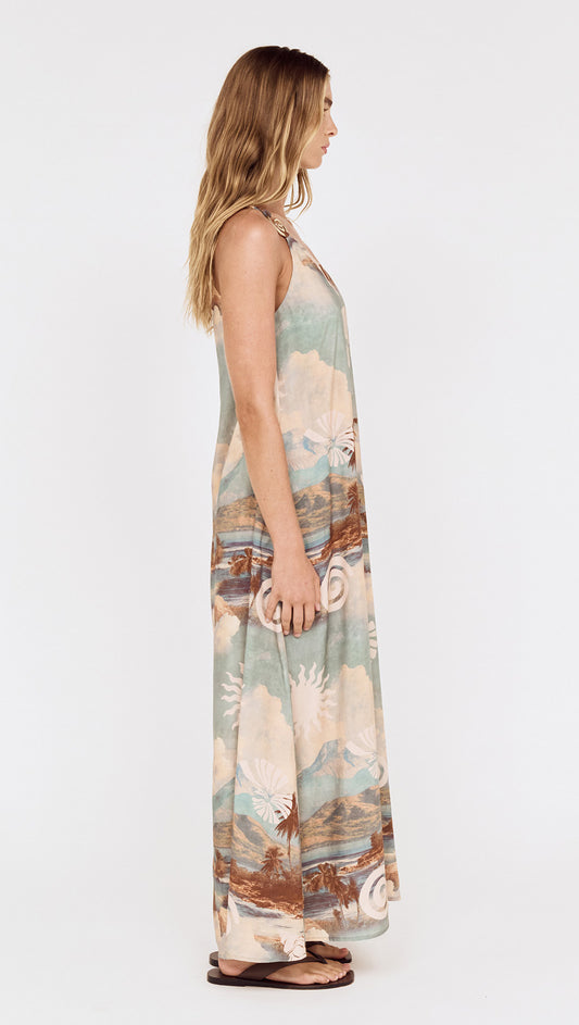 Side view of a model wearing the Island Print One Shoulder Maxi Dress showcasing its scenic print and relaxed silhouette.