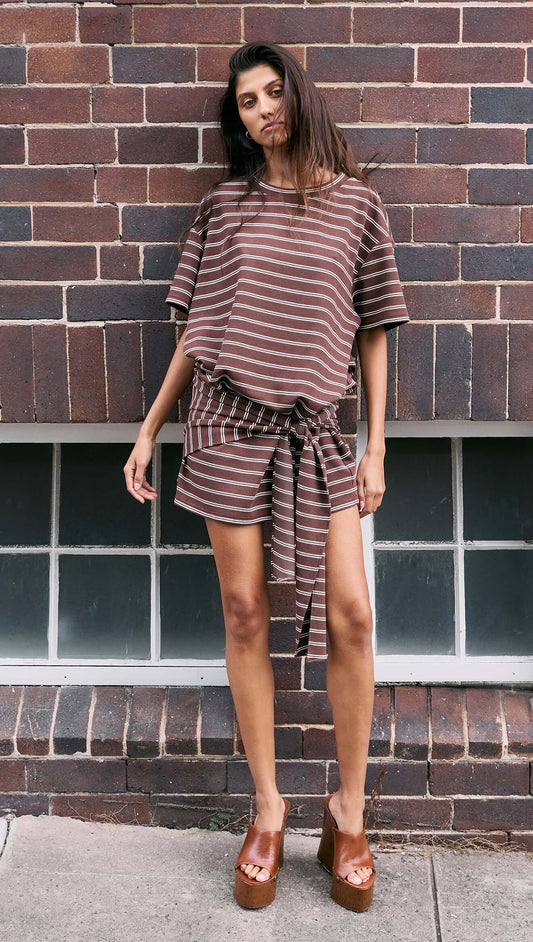 Model wearing a Striped Tie Waist Jersey Mini Dress with chocolate stripe print, featuring a relaxed style and adjustable tie at the waist.