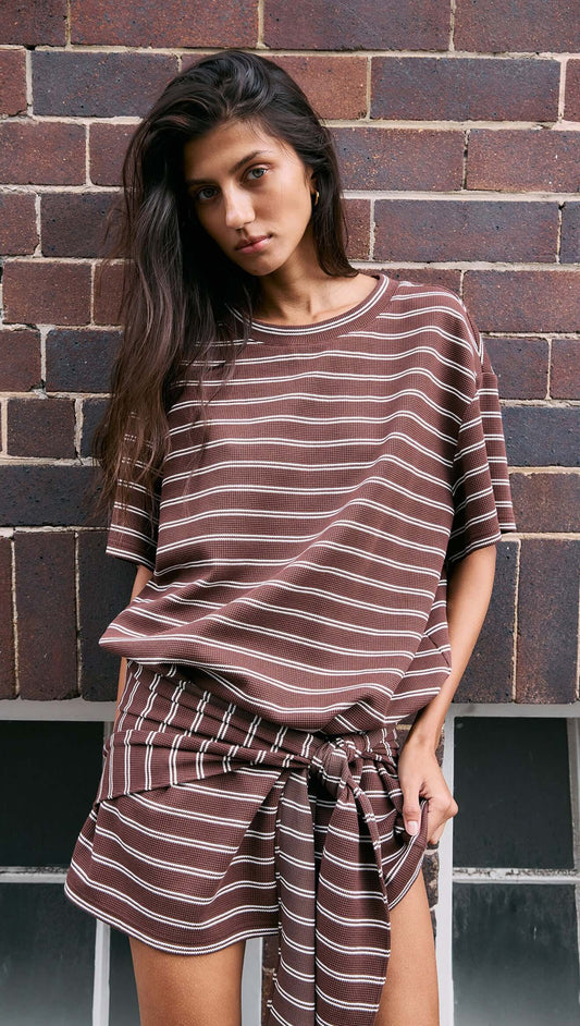 Model wearing a Striped Tie Waist Jersey Mini Dress featuring chocolate stripes and a relaxed fit.