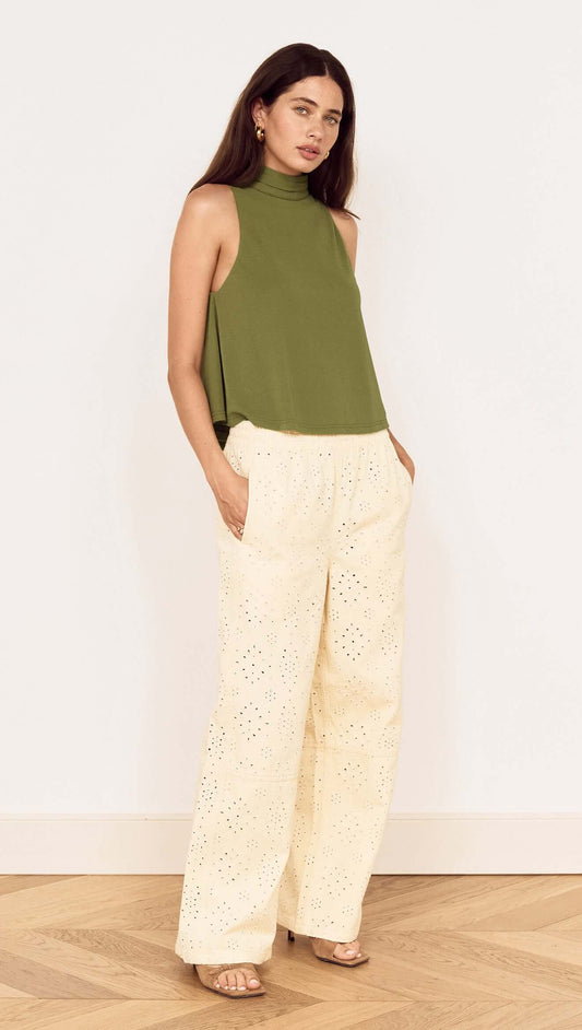 Model wearing a Green High Neck Jersey Top paired with light-colored pants, showcasing a stylish, relaxed outfit.