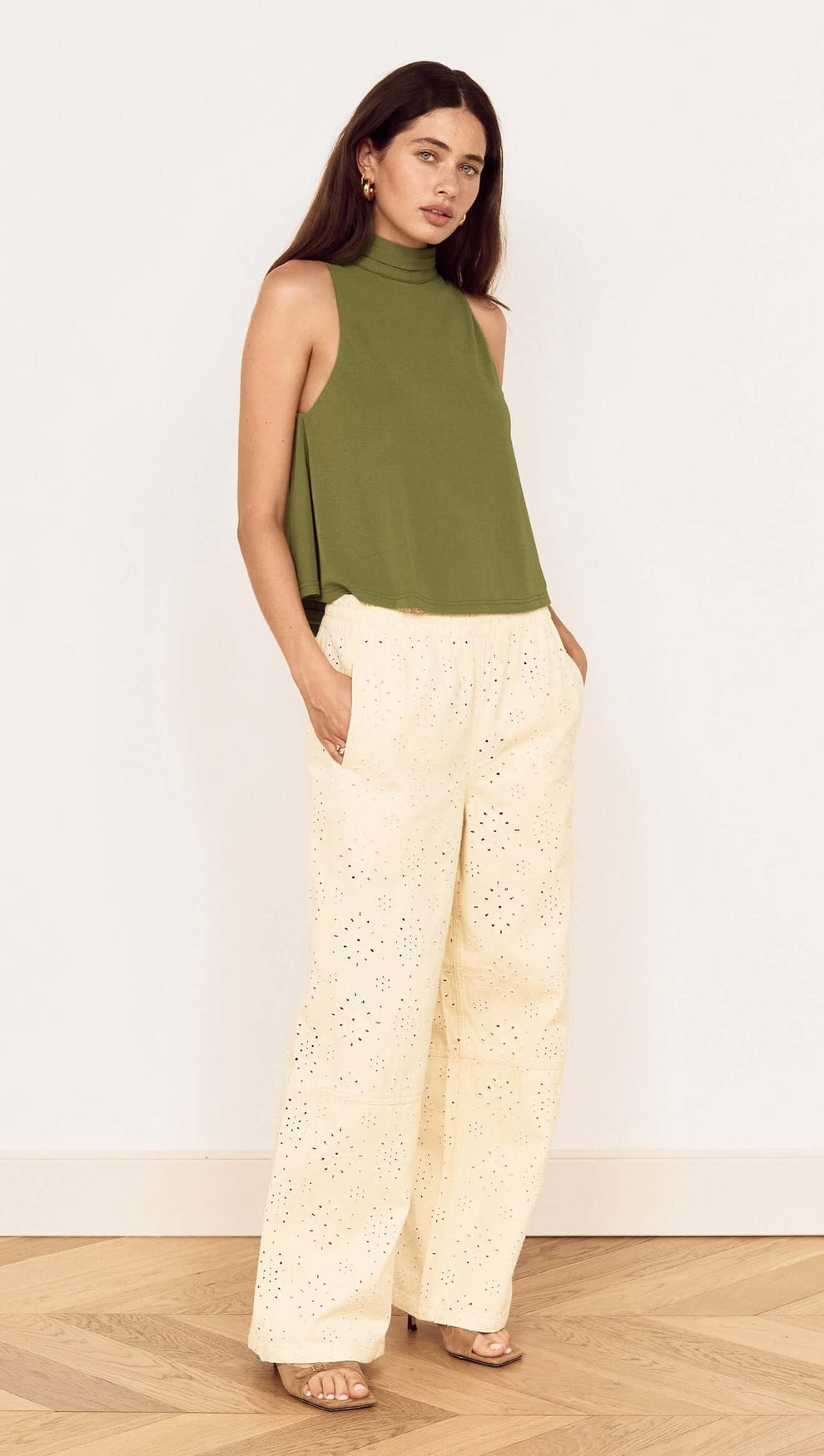 Model wearing a Green High Neck Jersey Top paired with light-colored pants, showcasing a stylish, relaxed outfit.