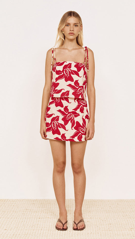 Cotton A-Line Mini Skirt in Red Floral, featuring bold floral print and A-line silhouette on model.