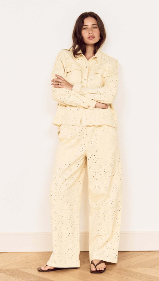 Model wearing a Cotton Denim Broderie Anglaise Jacket with matching bottoms, showcasing broderie cutwork design.