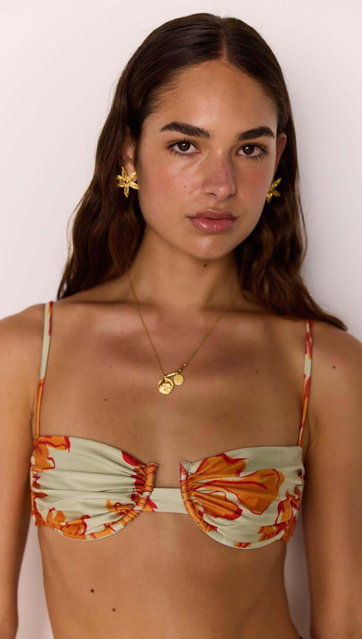 Model wearing the Green & Orange Gathered Bra Top with gathered cups and floral print.