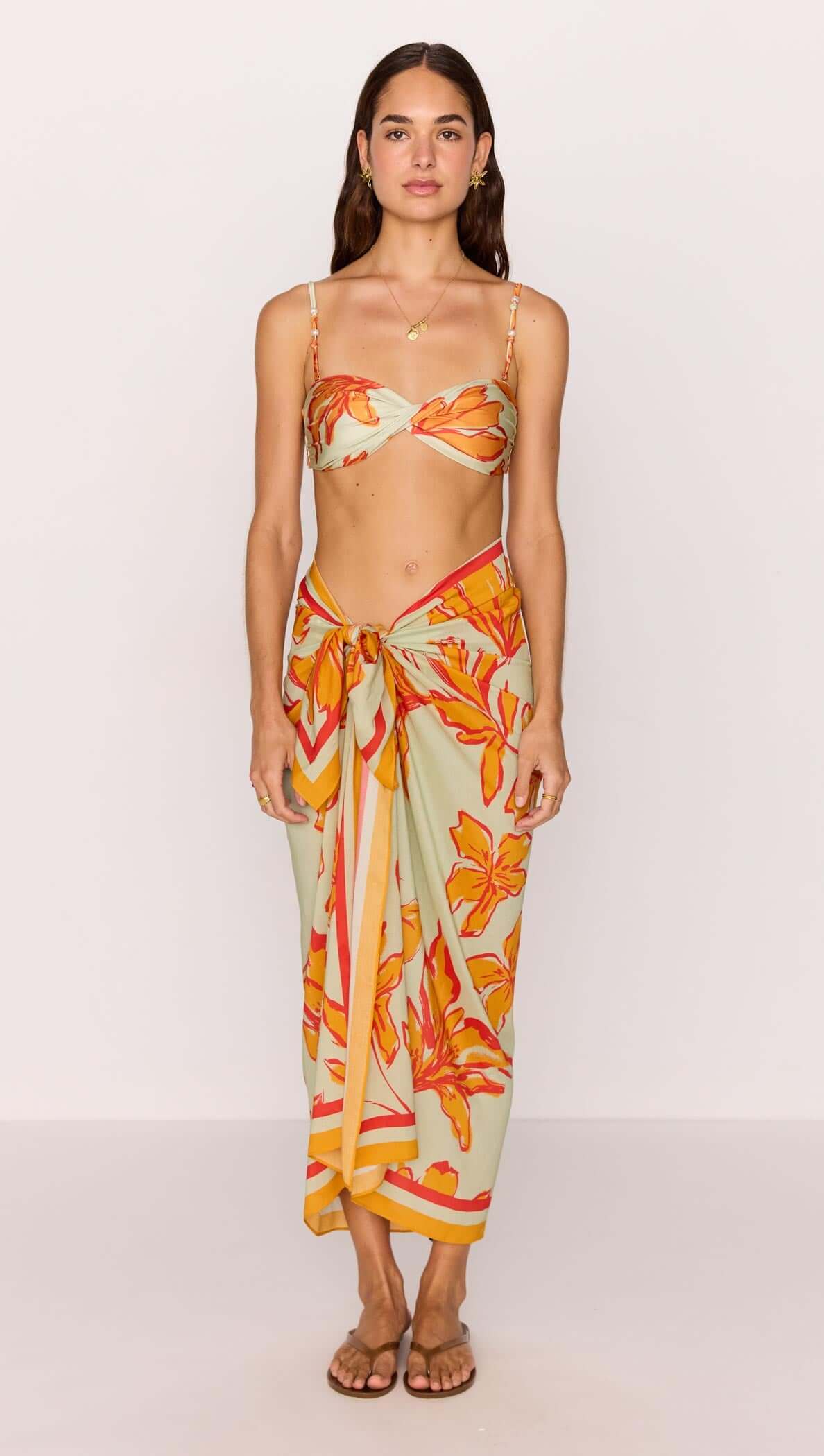 Green & Orange Twist Bikini Top featuring a floral print and adjustable straps, perfect for summer beach days.