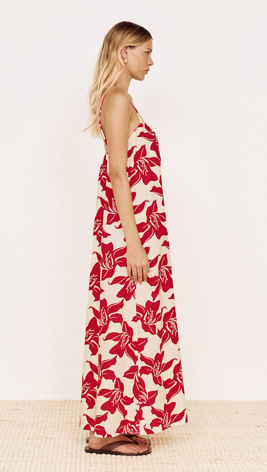Cotton Maxi Sun Dress in Red Floral worn by a model, showcasing its flowing silhouette and bold floral print.