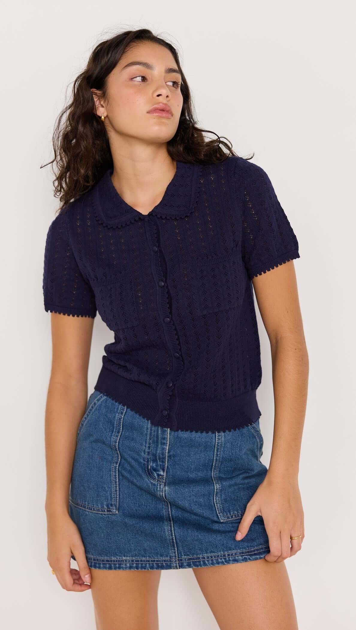 Navy pointelle knit tee with Peter Pan collar and scalloped trims, styled with a denim skirt.