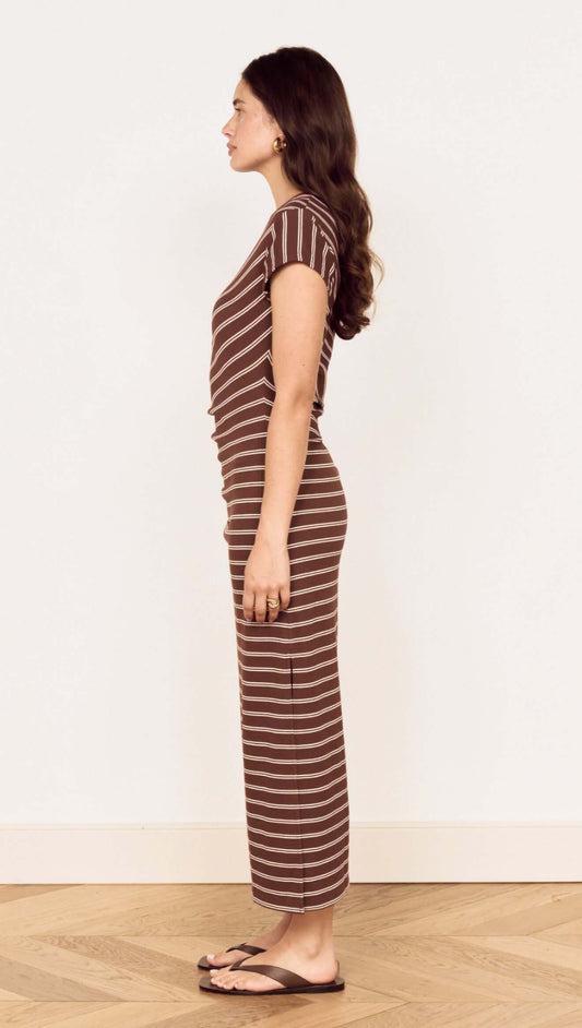Profile view of a model wearing a Striped Jersey Ruched Midi Dress with chocolate stripe print.