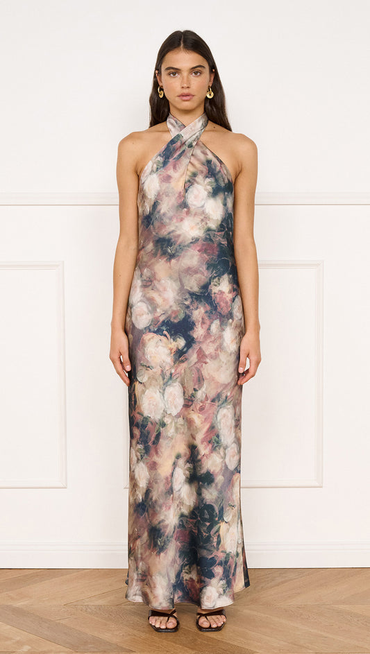 Satin Halter Neck Maxi Dress in Rose Floral worn by model, showcasing a floral design with a halter neckline and maxi silhouette.