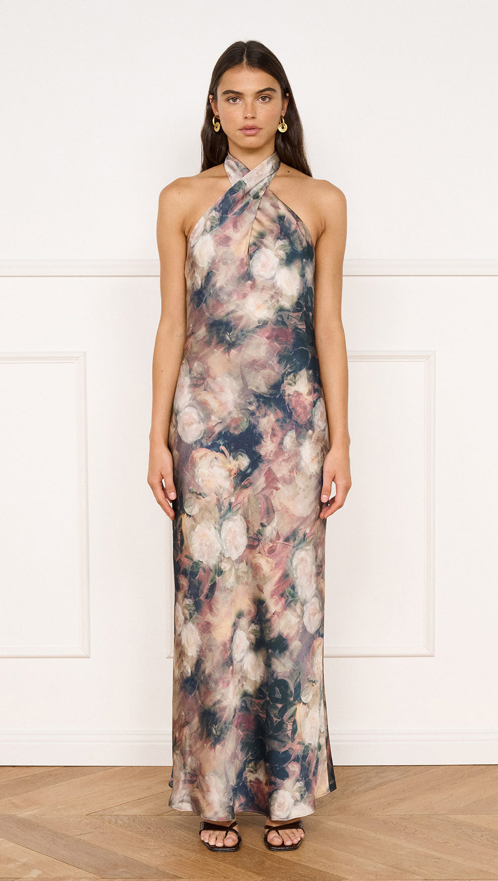 Satin Halter Neck Maxi Dress in Rose Floral worn by model, showcasing a floral design with a halter neckline and maxi silhouette.