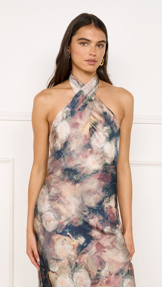 Satin Halter Neck Maxi Dress in Rose Floral worn by model, featuring abstract floral print and crossover halter neckline.