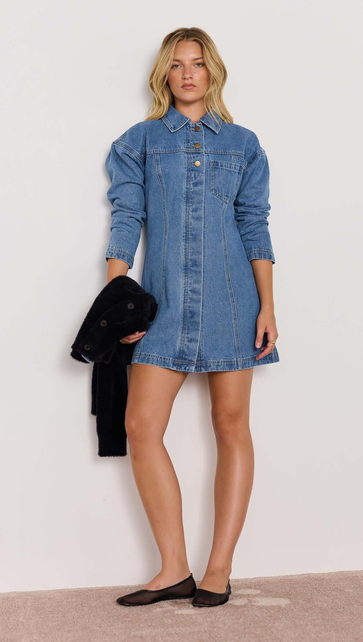 Model wearing a vintage blue Tully Denim Mini Dress with long sleeves and a collared neckline.