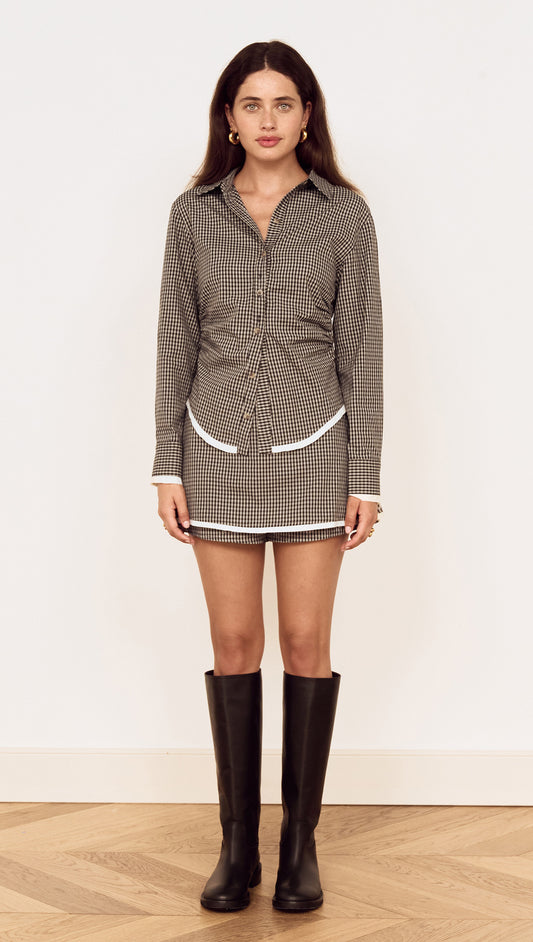 Model wearing a Contrast Hem Mini Skirt in Grey Check styled with a matching shirt and knee-high boots.
