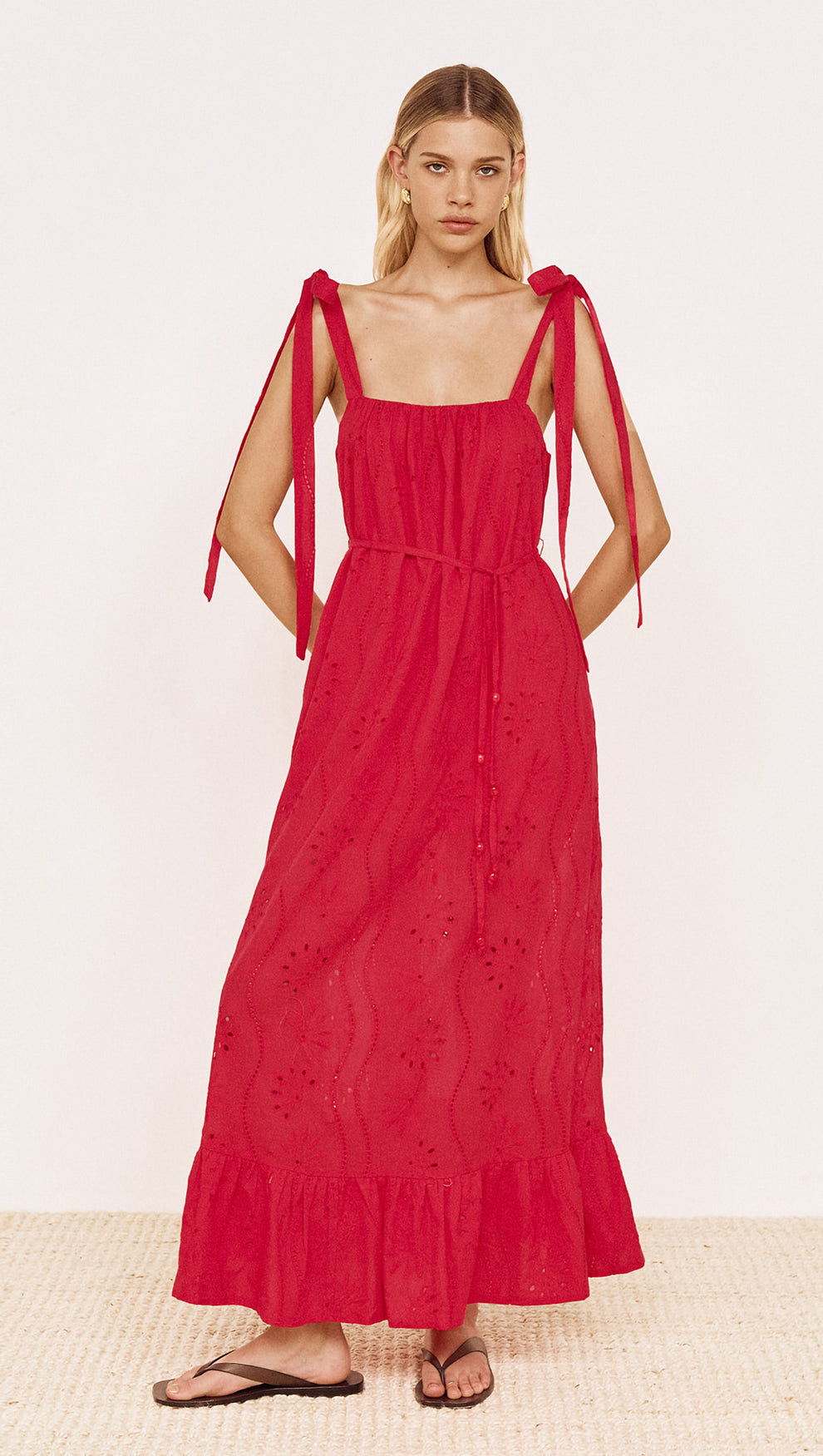 Cotton Broderie Maxi Sun Dress in Red worn by a model with tie shoulder straps and flowing silhouette.