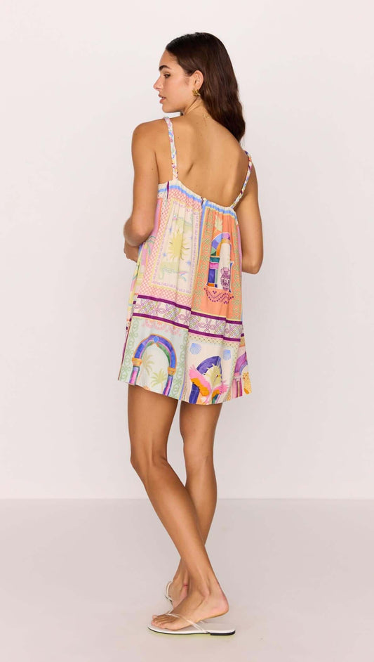 Back view of a woman wearing a multicolour print babydoll mini dress, perfect for summer style and casual outings.