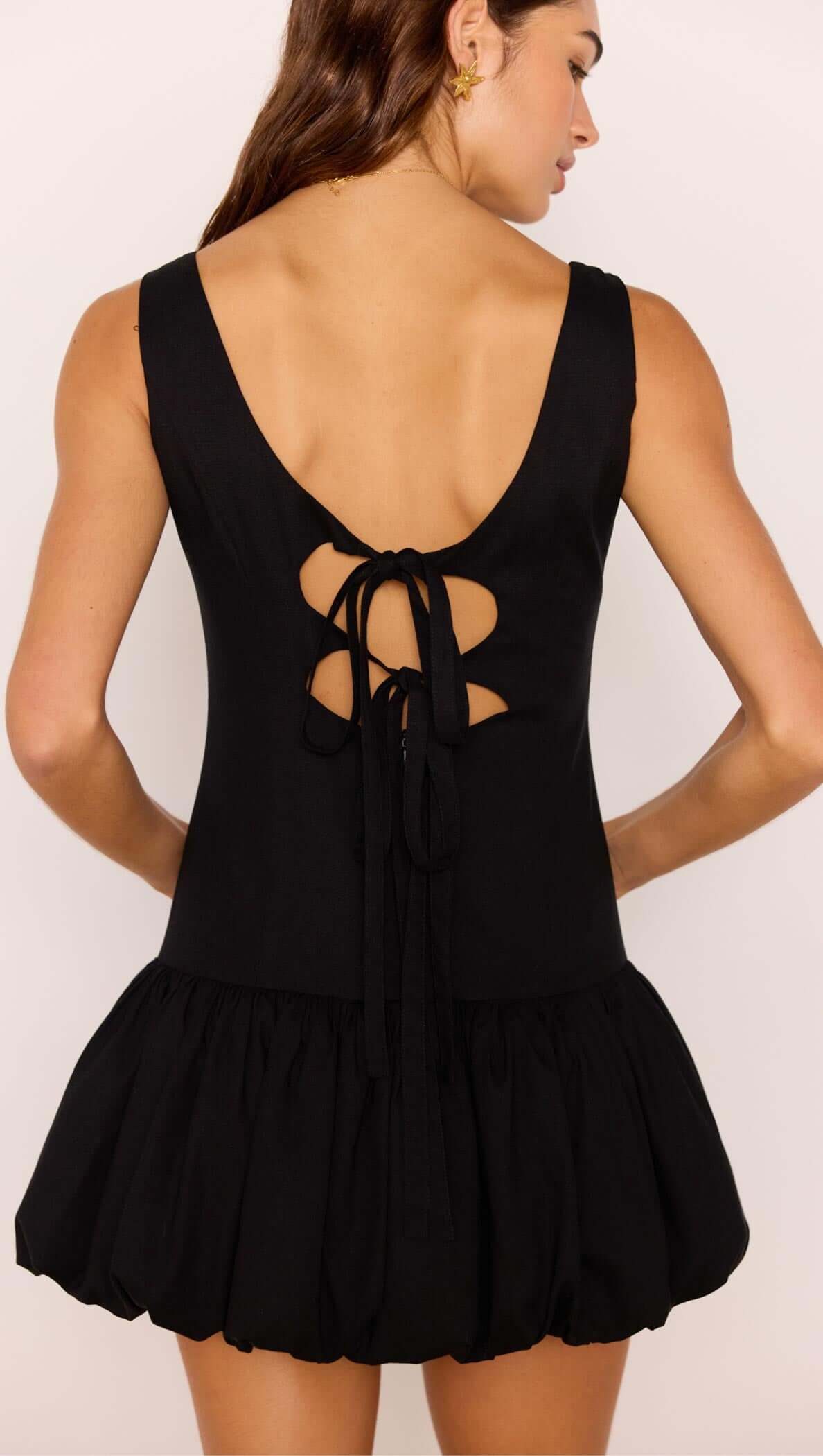 Back view of the Cotton Linen Blend Black Bubble Mini Dress showcasing scoop neckline and tie detailing