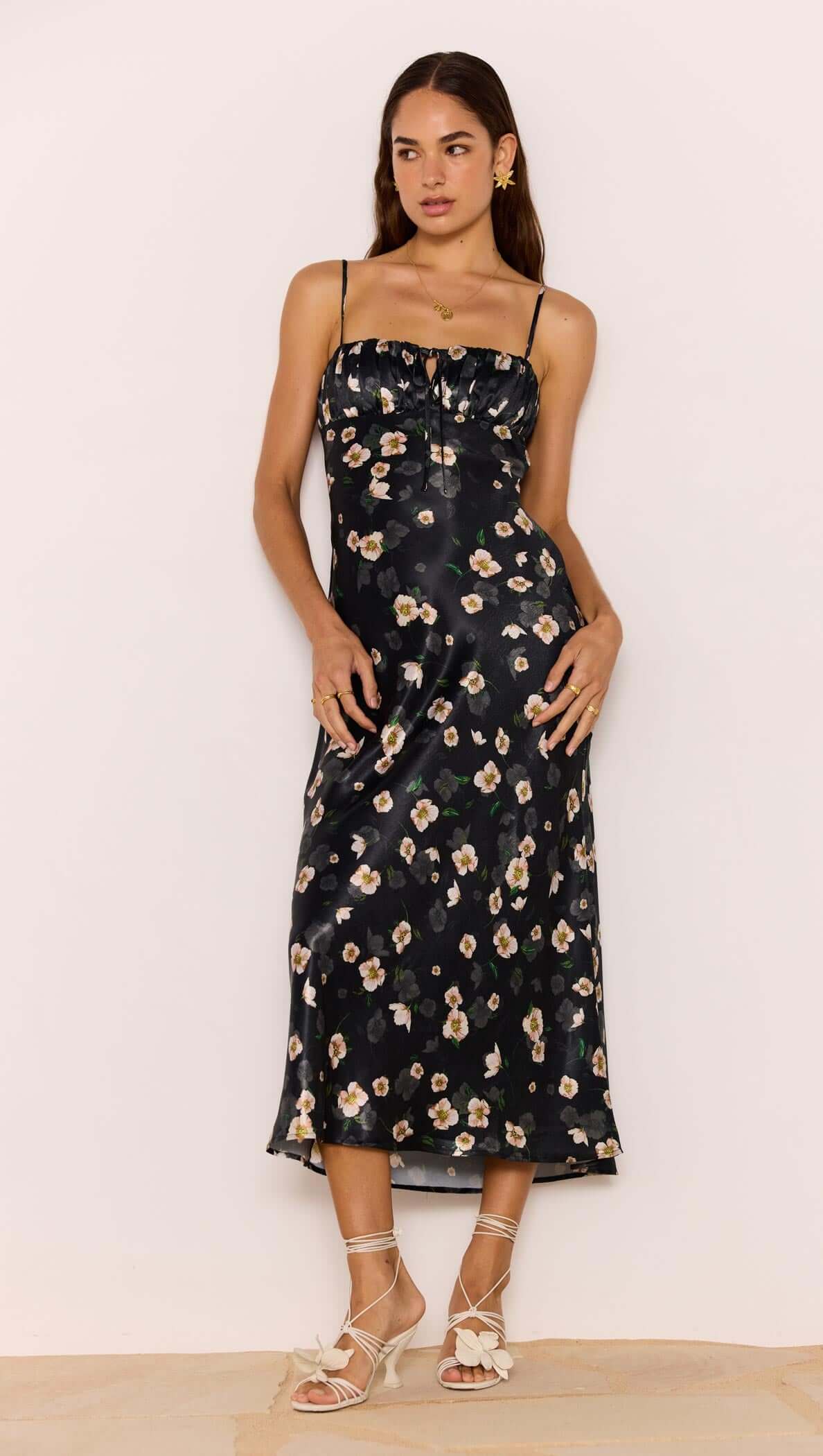 Black Floral Bias Midi Dress showcased on a model, featuring a soft satin finish and flattering bias cut.