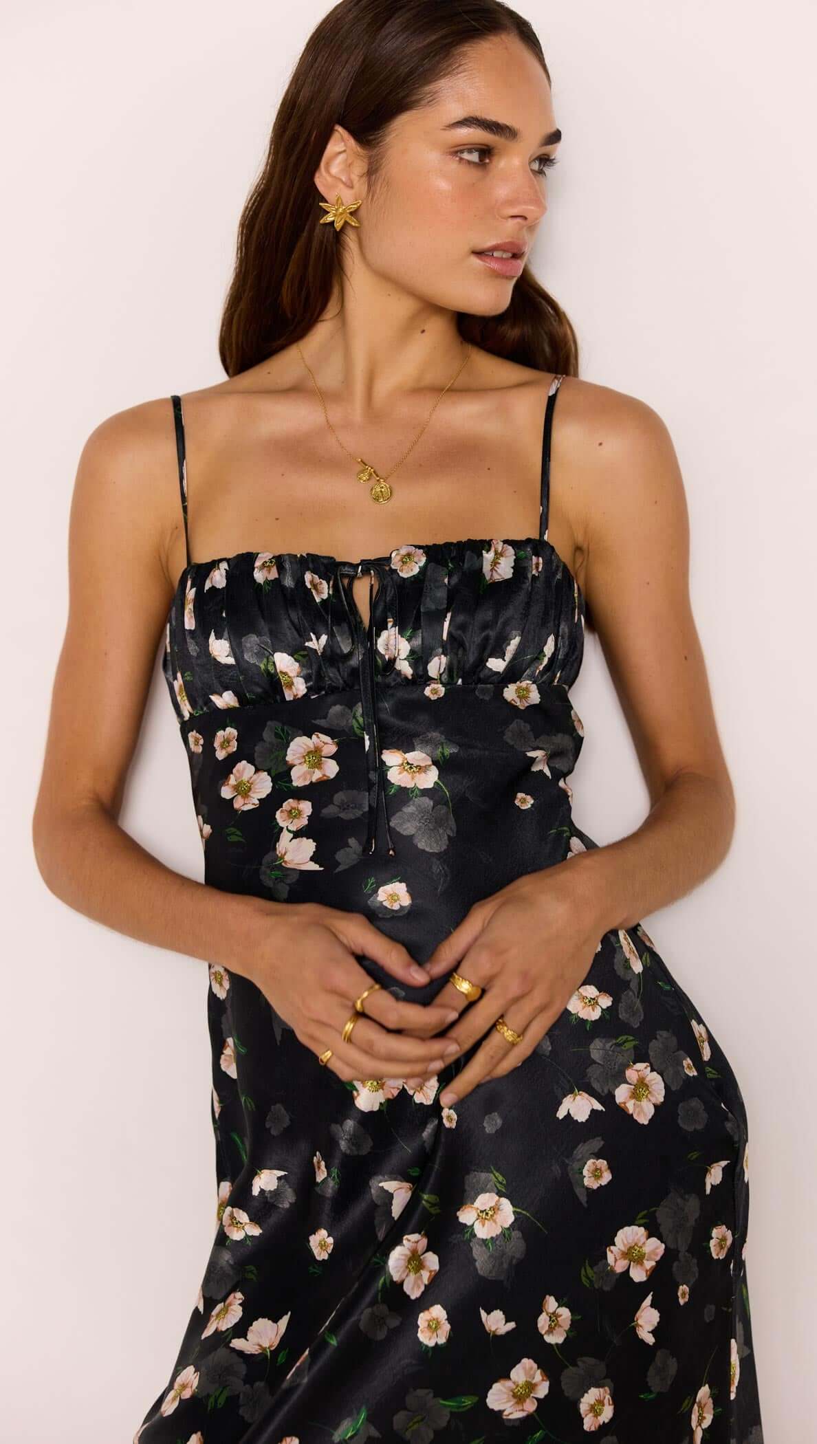 Black Floral Bias Midi Dress displayed on a model showcasing the ruched bust and floral satin finish.