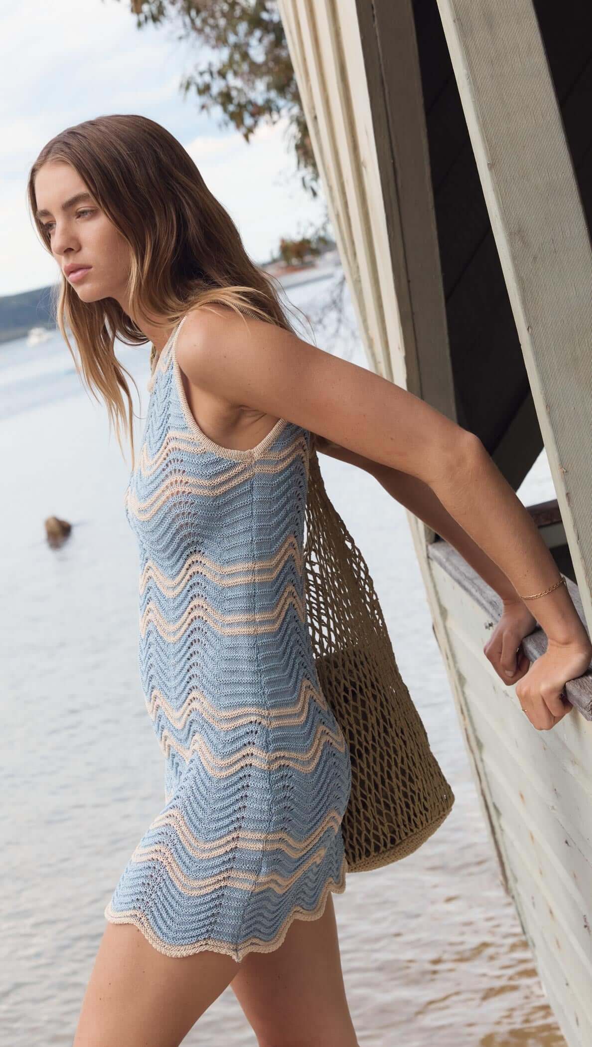 Blue & Cream Knit Mini Dress by Solange, featuring a soft wave knit pattern, perfect for summer outings with a stylish bag.