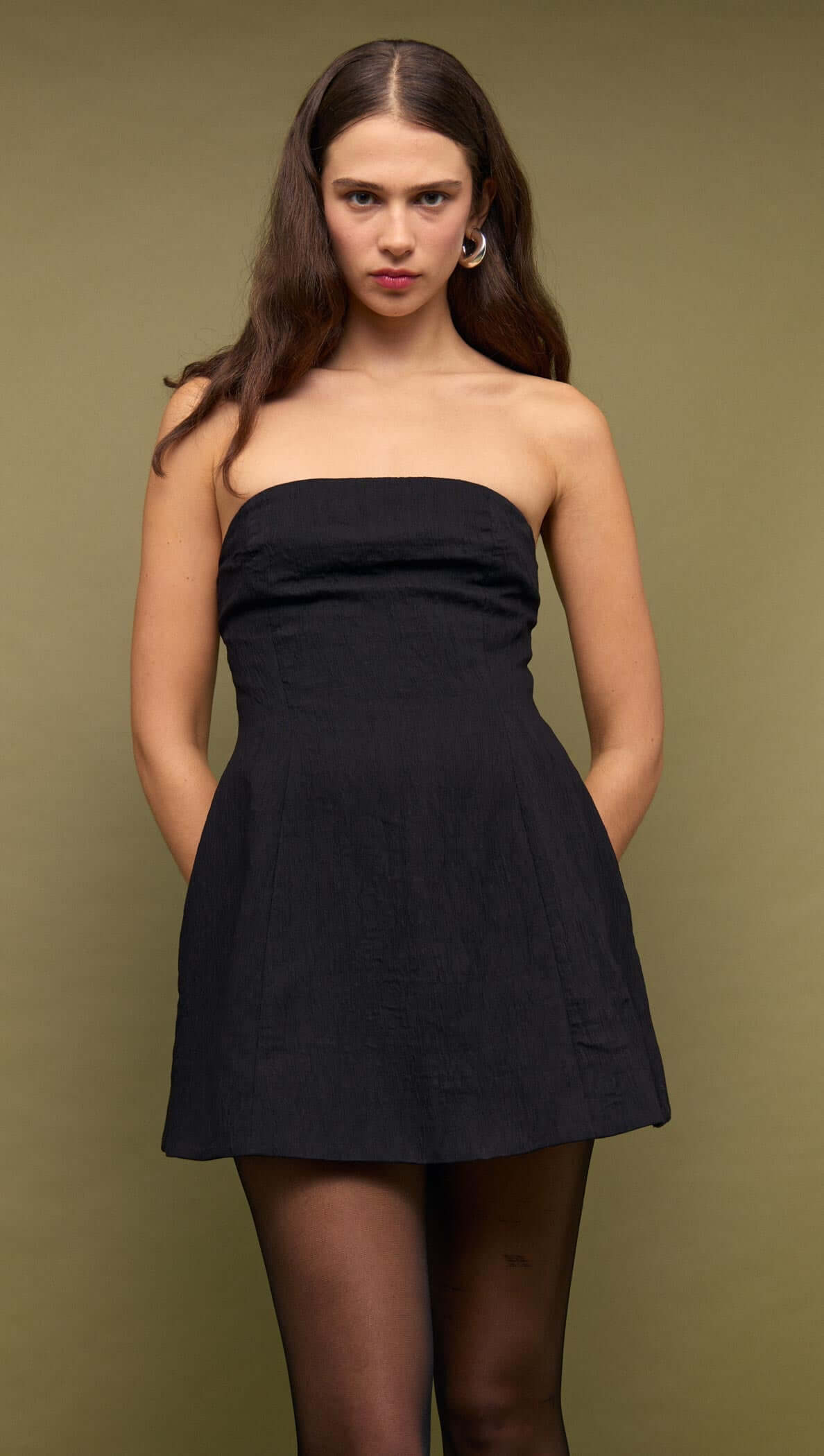 Black Strapless Peplum Mini Dress on model with a structured fit-and-flare silhouette, perfect for evening occasions.