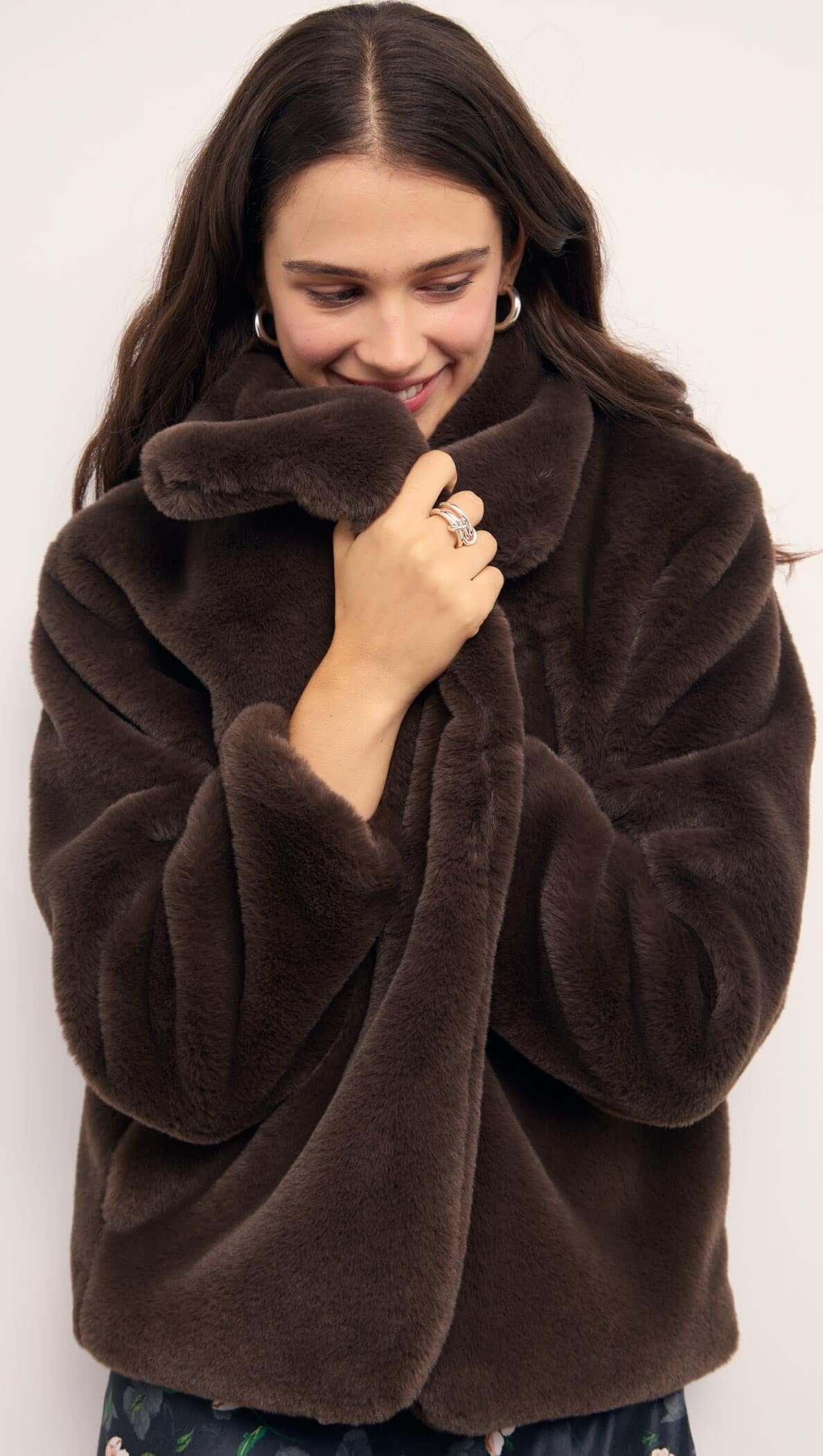 A model wearing a cozy Brown Faux Fur Coat, showcasing its soft texture and oversized collar.