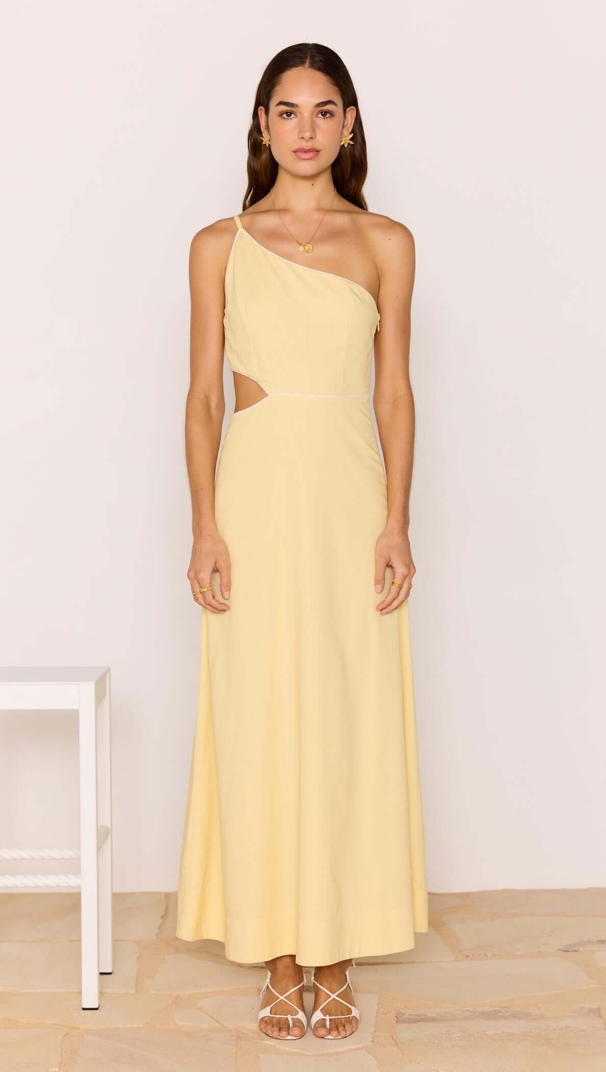 Butter Yellow Asymmetric Cut Out Maxi Dress shown on model, featuring one-shoulder neckline and subtle waist cut-out.