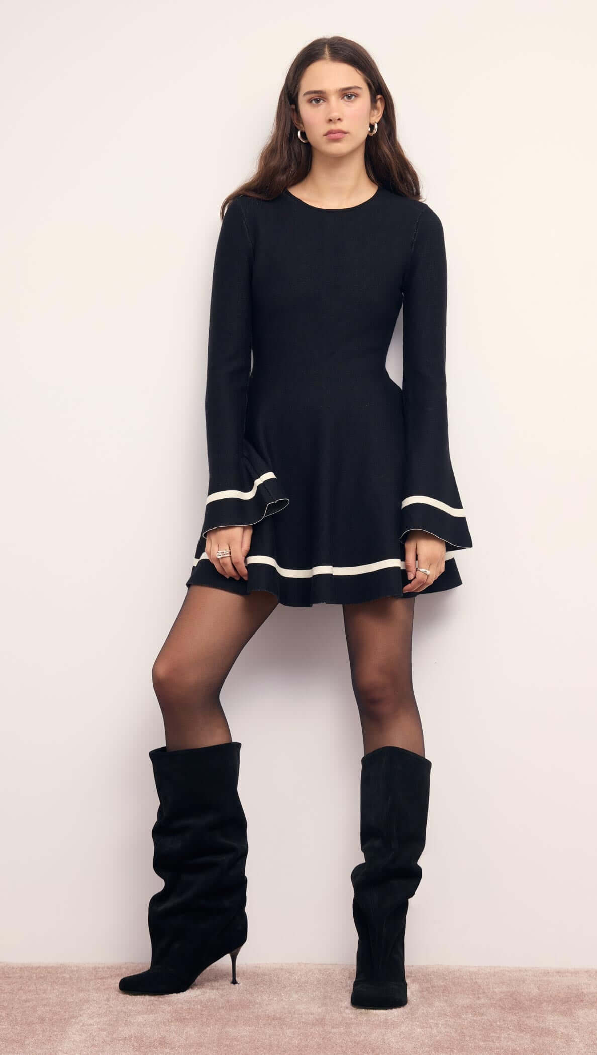 Black Peplum Knit Mini Dress With Contract Trim featuring long sleeves and flared cuffs