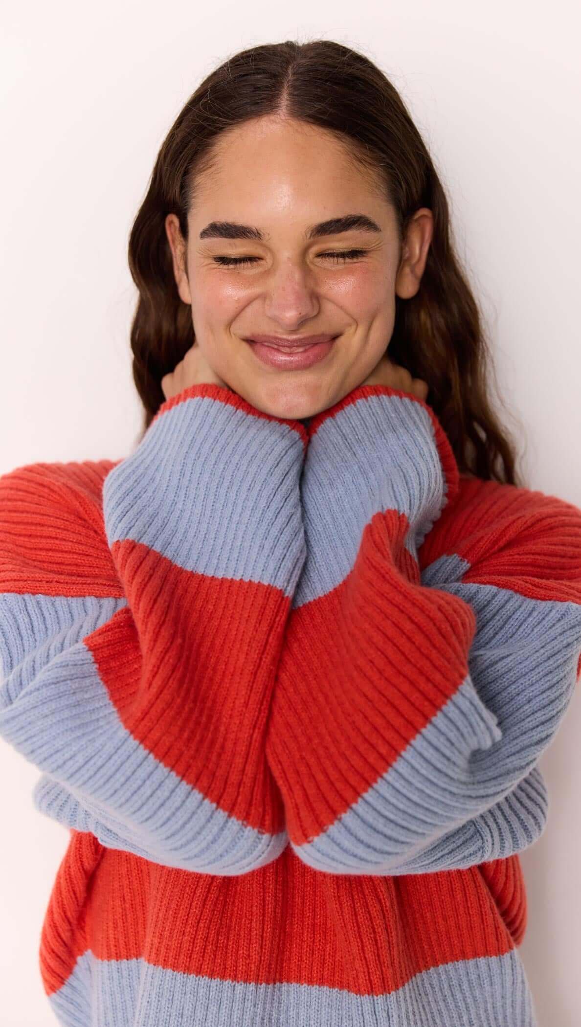 Freja Stripe Chunky Knit in bold red and blue stripes, featuring a relaxed fit and flared sleeves by MINKPINK.