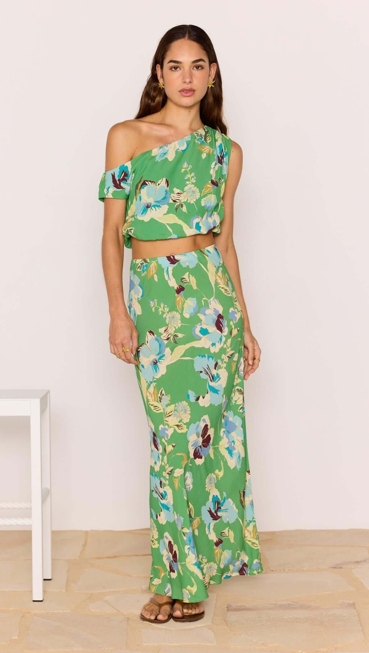 Model wearing a Green Floral Crop Top paired with a matching skirt, showcasing a vibrant floral pattern and summer style.
