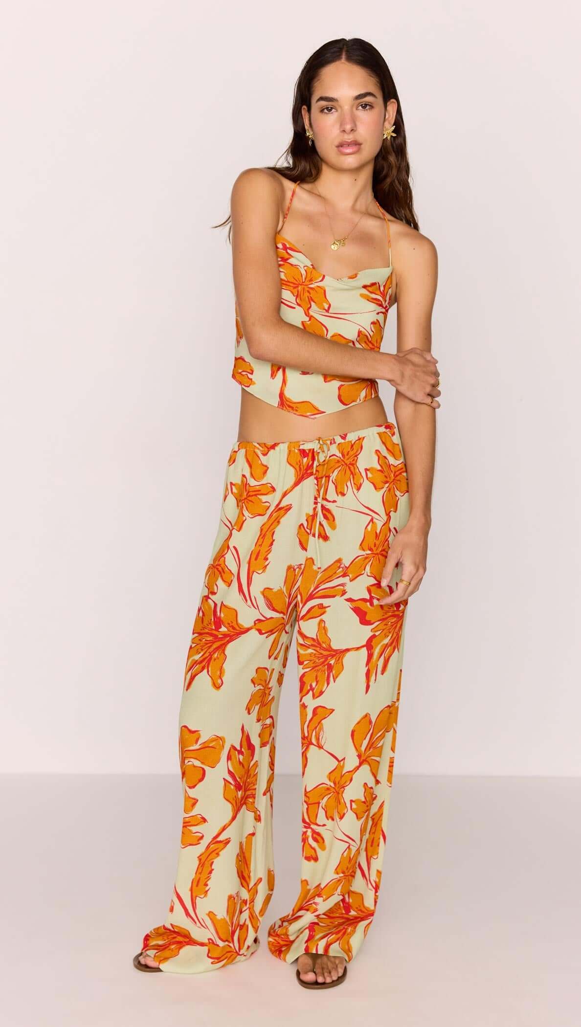 Model wearing Green & Orange Floral Drawstring Wide Leg Pant with matching top, showcasing vibrant floral design.