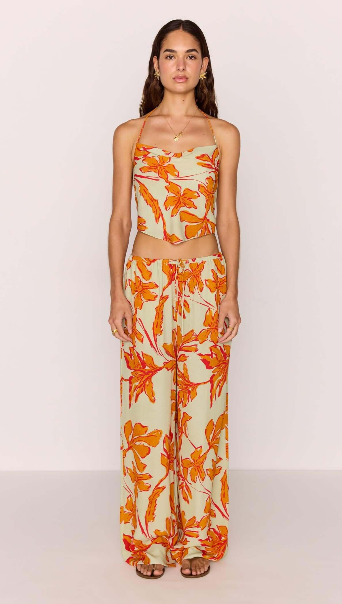 Model wearing Green & Orange Floral Drawstring Wide Leg Pant with matching top, showcasing vibrant floral print.