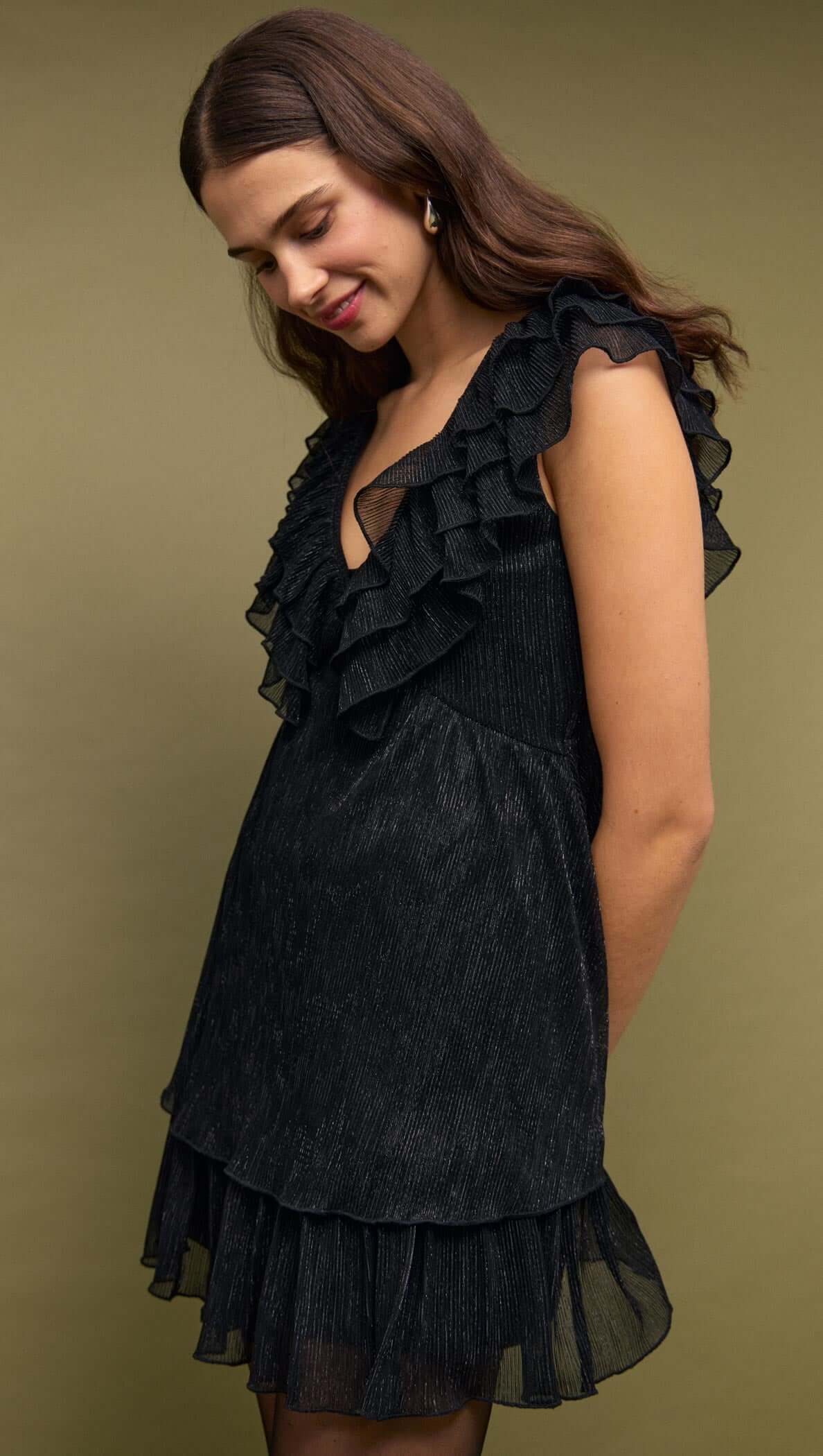 Black Shimmer Plisse Frill Mini Dress on model with layered ruffles and deep V neckline.