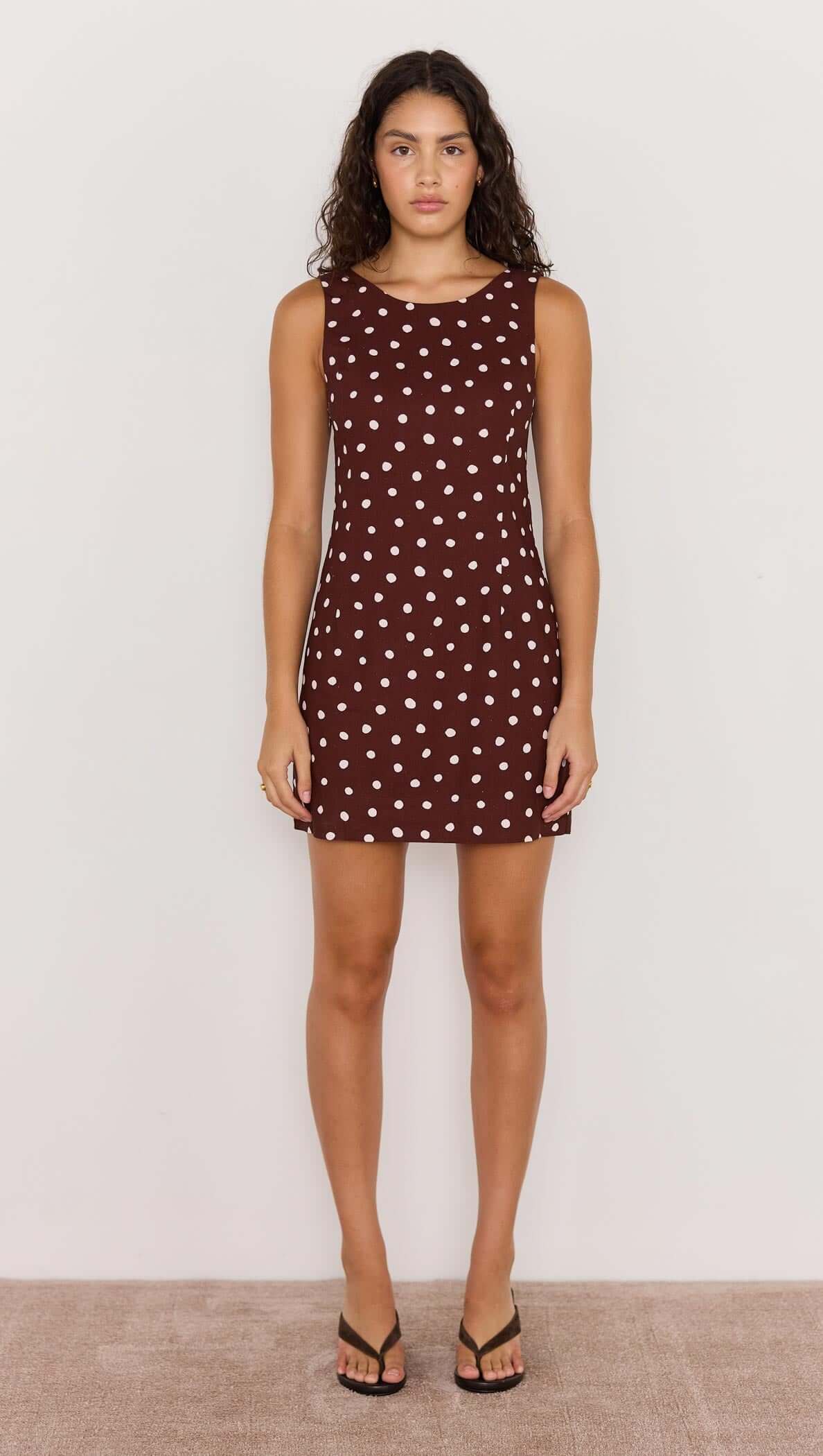 Sleeveless Cedar Mini Dress in chocolate brown spot print, featuring scoop back and fit-and-flare silhouette.