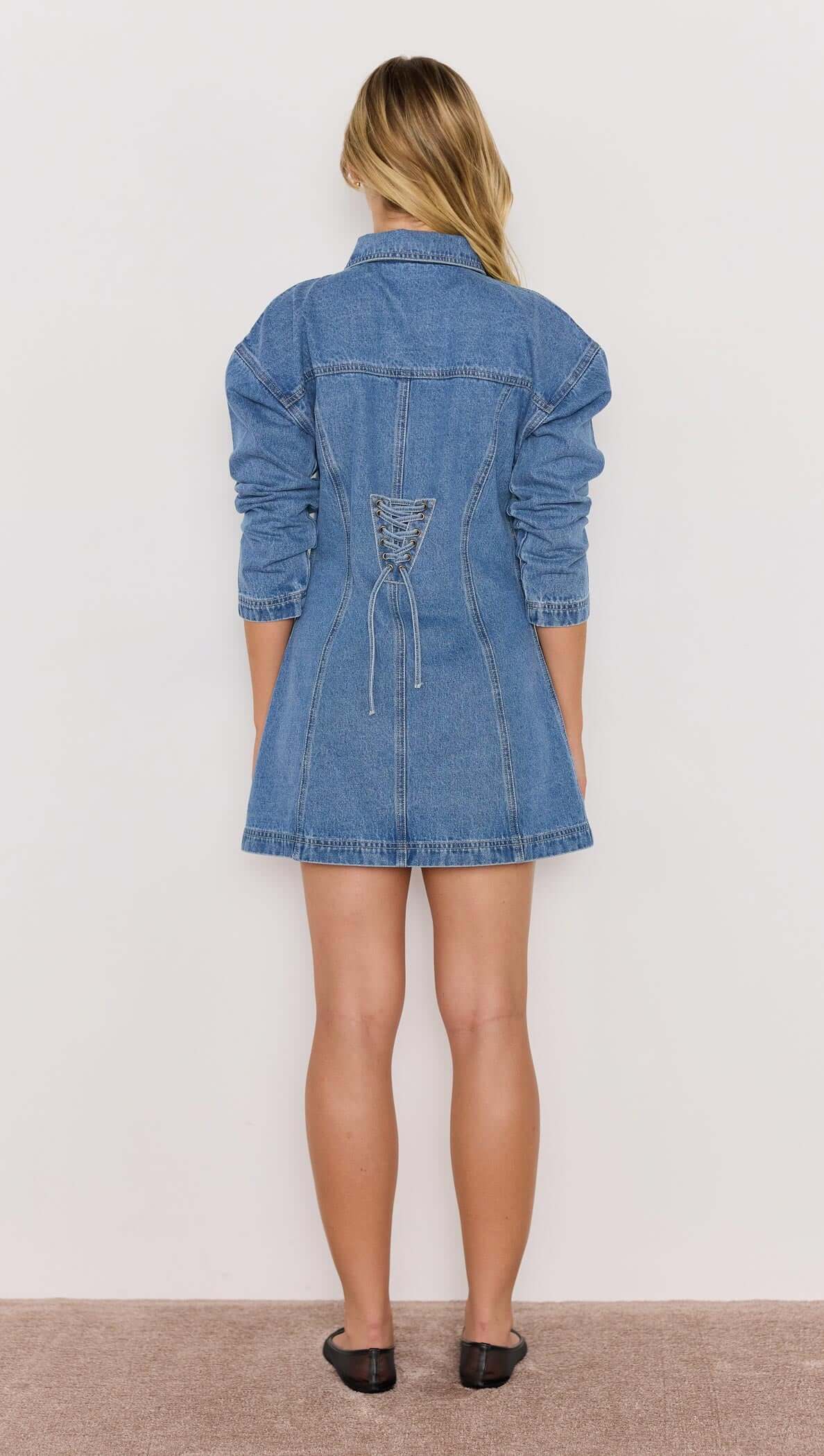 Back view of the Tully Denim Mini Dress showcasing lace-up back detail and tailored A-line silhouette in vintage blue.