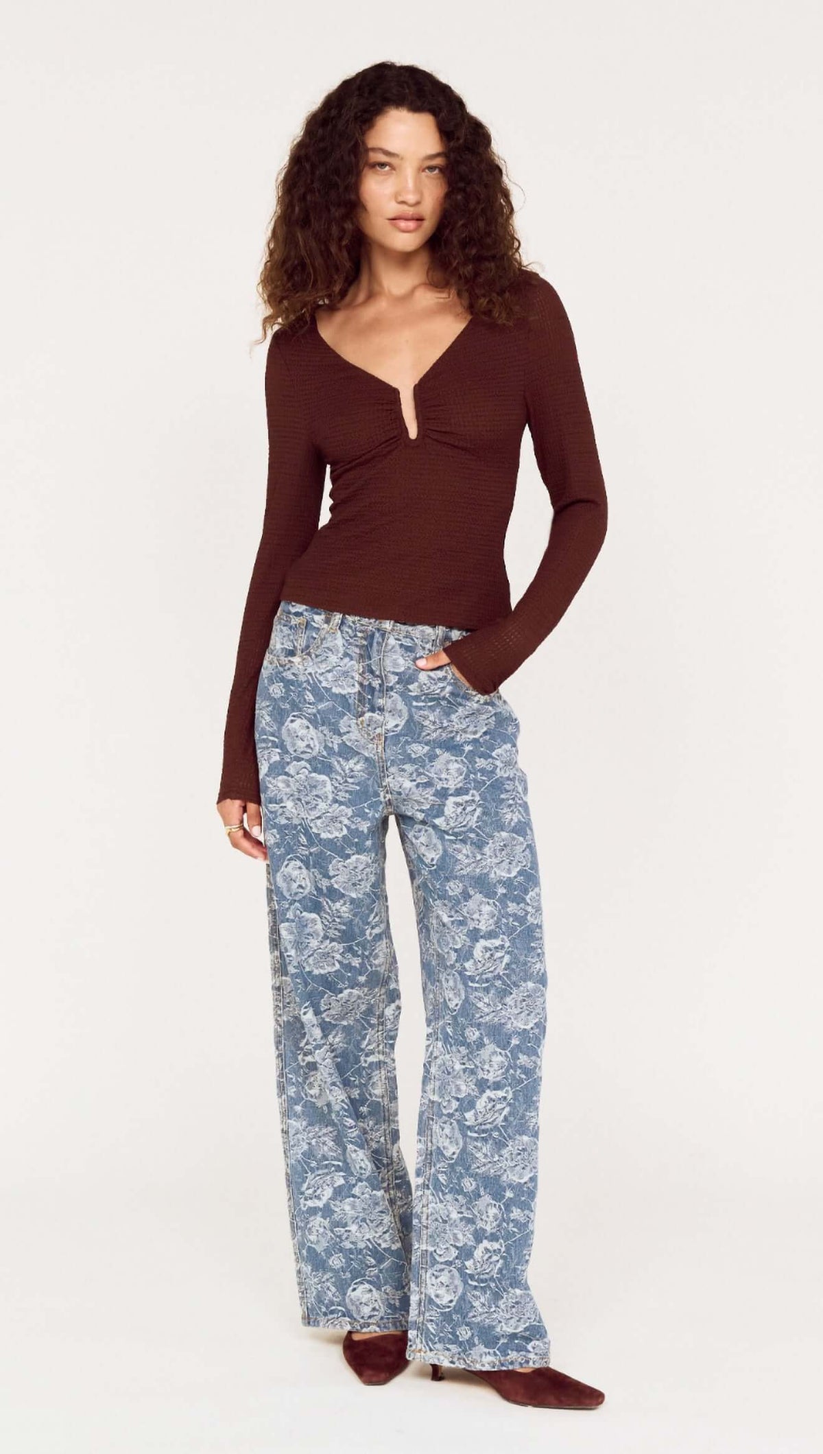 Model wearing U Wire Textured Jersey Top in Chocolate with blue floral wide-leg pants.