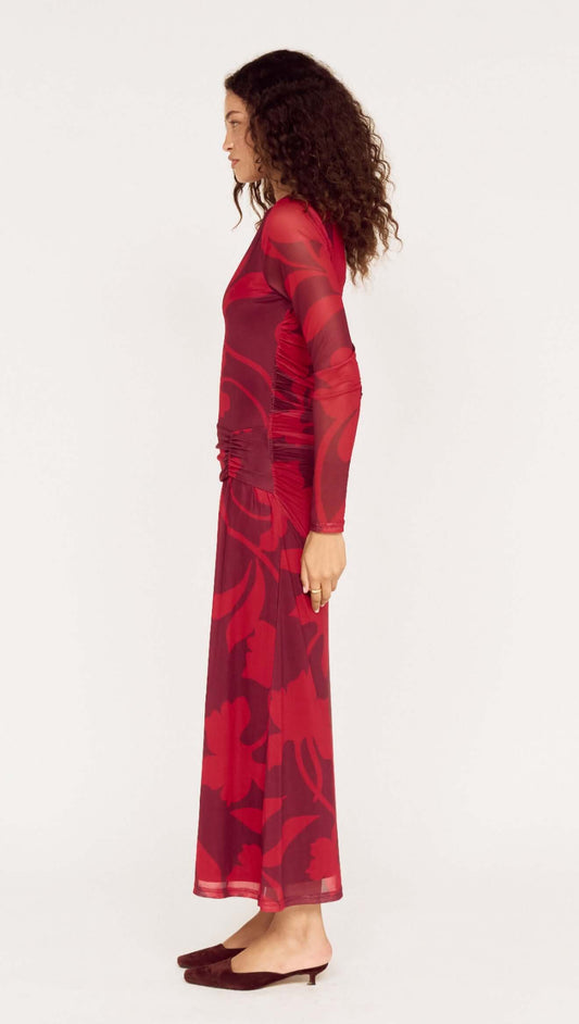 Woman wearing an Oversized Floral Mesh Midi Dress with Gather Detail in red, showcasing a side view of the elegant design.