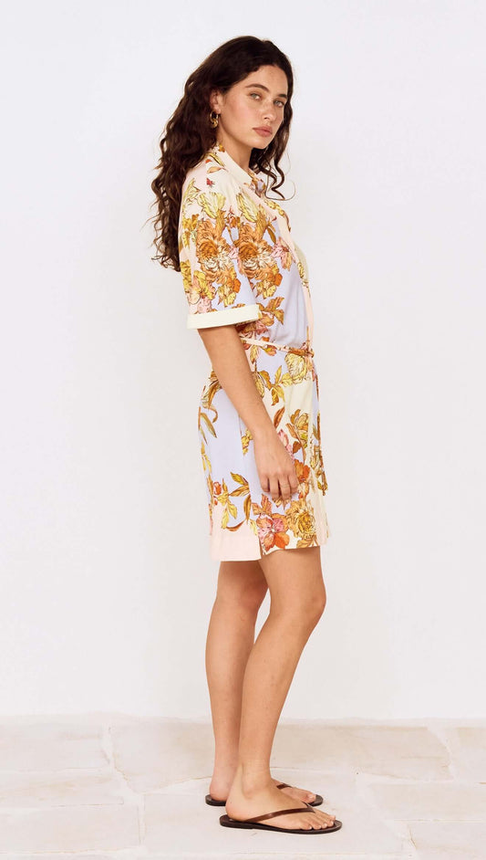 Pastel Floral Mini Shirt Dress worn by a model showcasing a side view of the garment with floral print design.