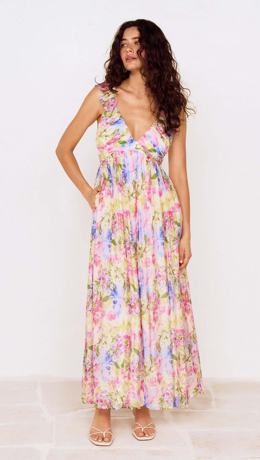 Model wearing a Watercolour Floral Ruffle Maxi Dress featuring a pastel floral print and ruffle shoulder straps.