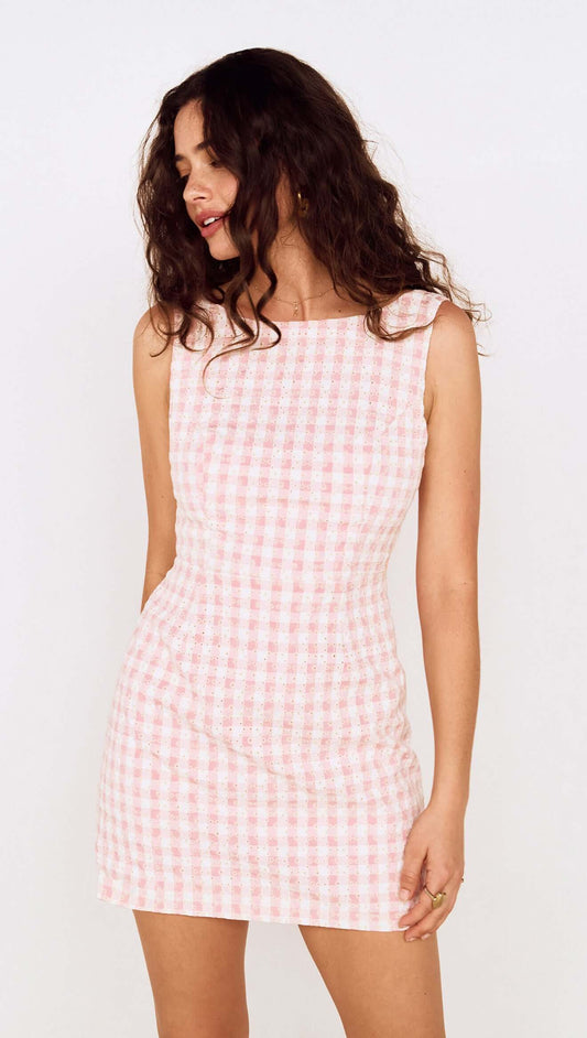 Model wearing a Pink Gingham Tie Back Cotton Mini Dress with a fitted silhouette and open back design.