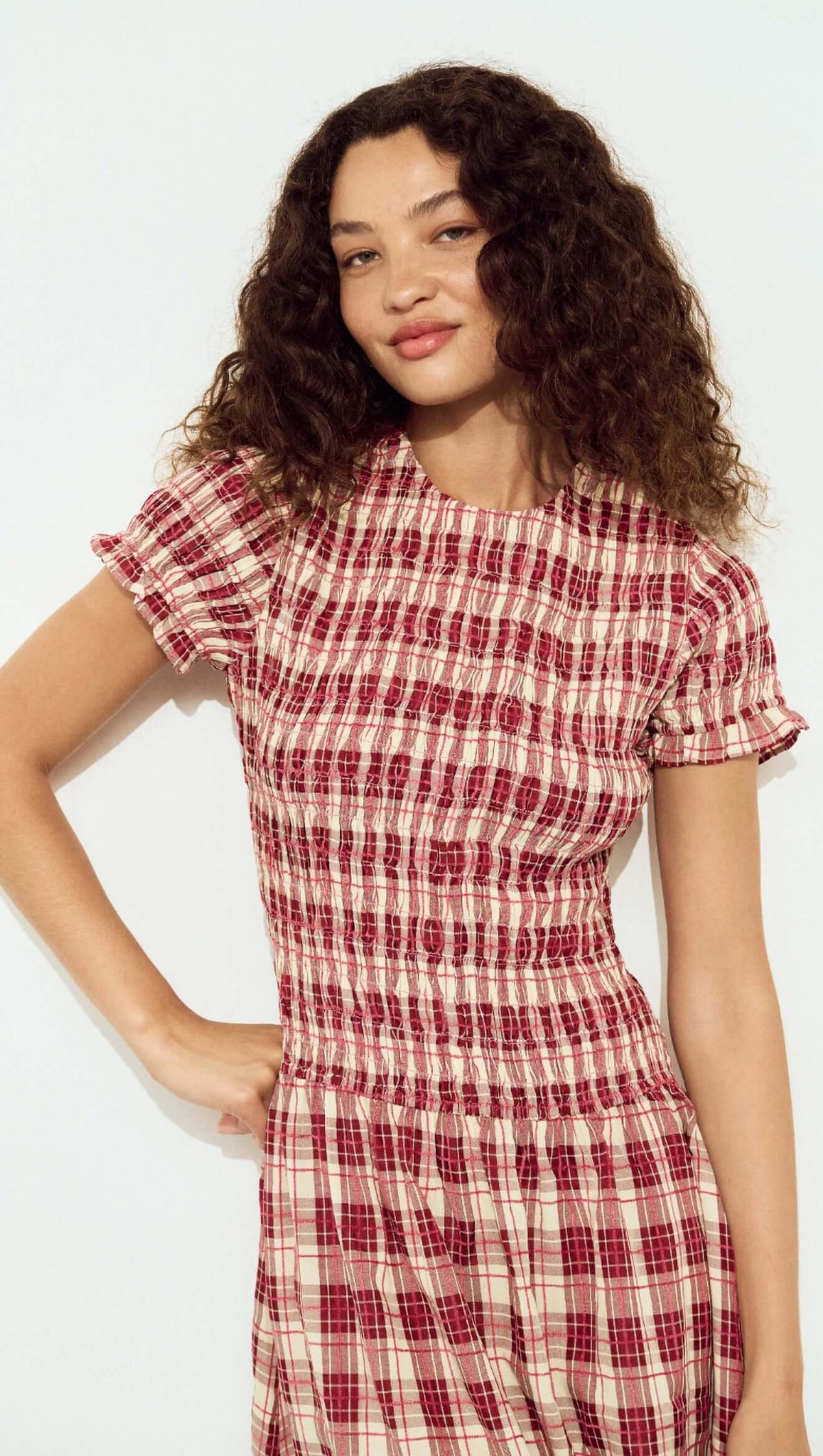 Model wearing a Short Sleeve Shirred Check Midi Dress with a plaid pattern and short sleeves, showcasing a vintage-inspired style.