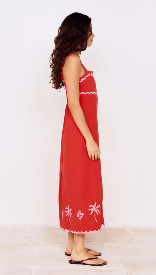 Side view of a model wearing a Red and Pink Embroidery Detail Midi Dress with palm embroidery and adjustable straps.