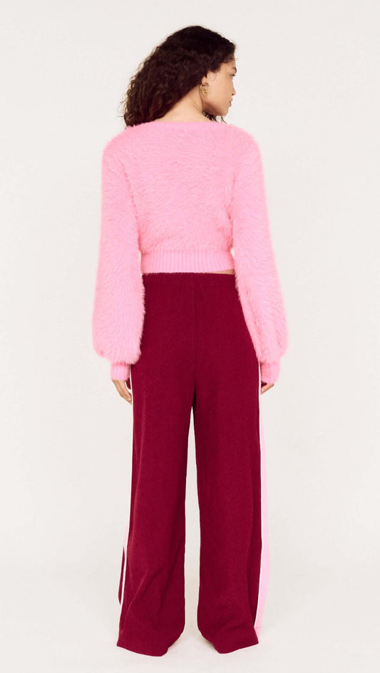 Clio Cropped Fuchsia Pink Fluffy Jumper worn with matching maroon pants, showcasing a back view of the stylish outfit.