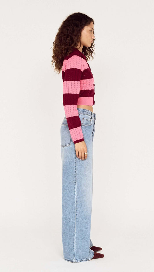 Model showcasing the Pink Stripe Pointelle Knit Cardi in pink and burgundy stripes, styled with high-waisted jeans.