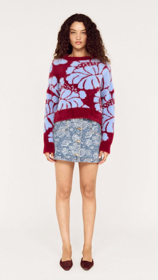 Model wearing the Intarsia Floral Soft Touch Jumper paired with a denim skirt, showcasing the vibrant floral design.