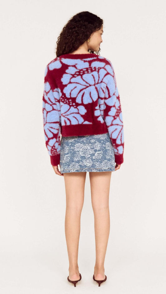 Back view of a model wearing the Intarsia Floral Soft Touch Jumper in maroon and blue with a denim skirt.