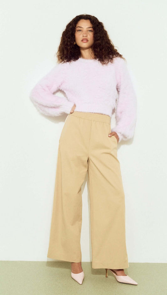 Cropped Baby Pink Fluffy Jumper styled with wide-leg beige pants and high heels, showcasing a chic, casual look.